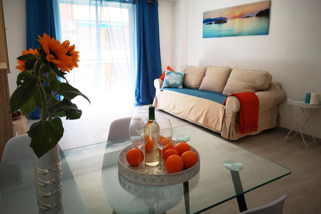 a living room with a glass table with oranges on it at 3 Bedroom 150 m from the beach in Torrevieja