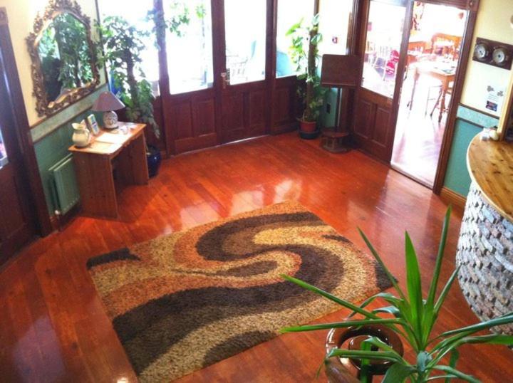 a room with a rug on a wooden floor at Pier House Bed & Breakfast in Inis Mor