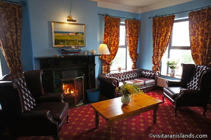 a living room with couches and a fireplace at Pier House Bed & Breakfast in Inis Mor