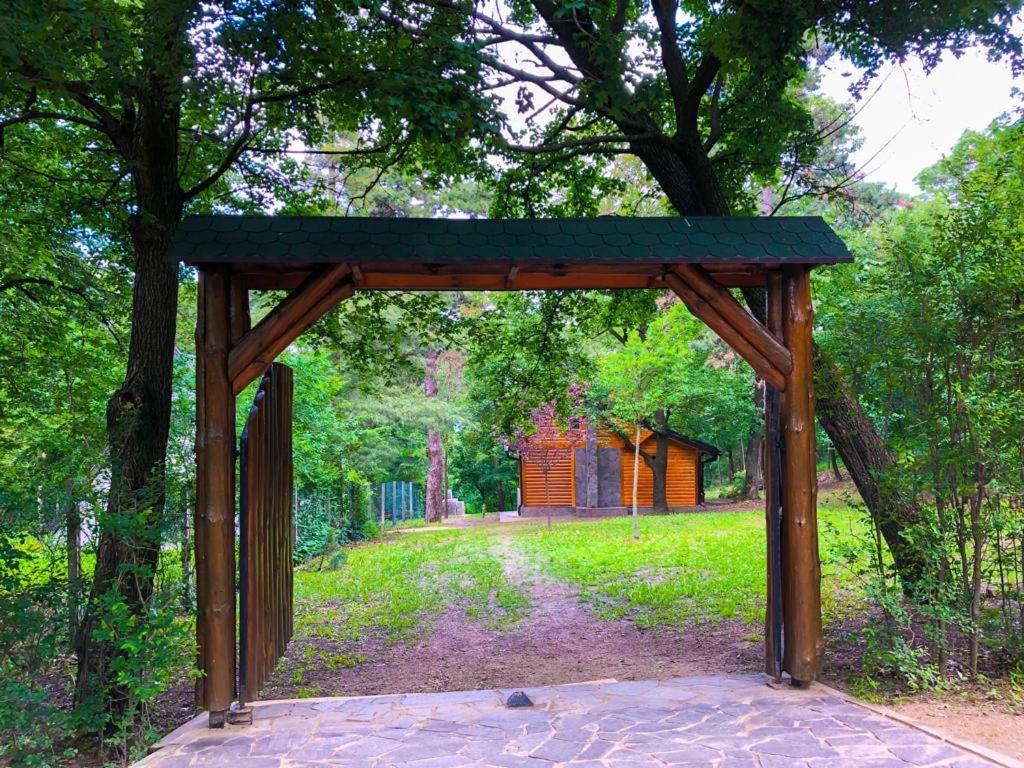 a wooden pavilion in the middle of a park at Brvnara Vršac in Vršac