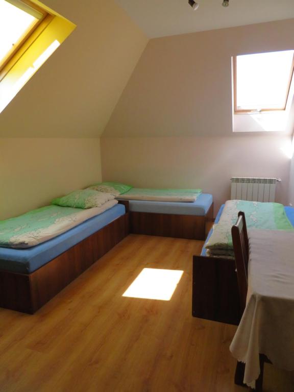 a room with two beds in a attic at Agroturystyka Agnieszki Murszewskiej in Sandomierz