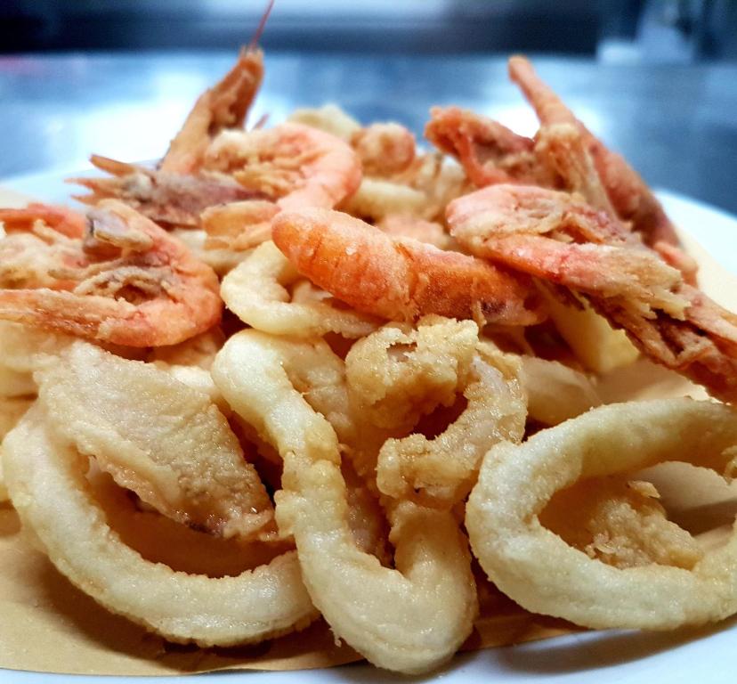 a pile of onion rings on a white plate at Hotel Villa Principe in San Nicola Arcella