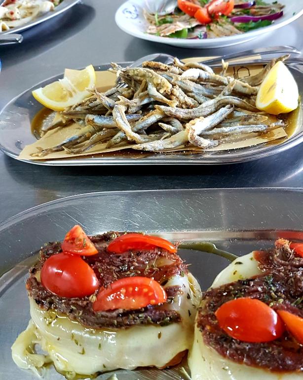a plate of food with a plate of food with tomatoes at Hotel Villa Principe in San Nicola Arcella