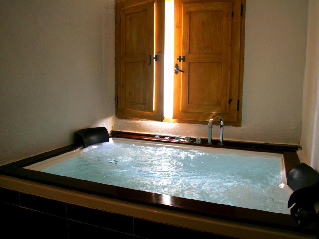 a hot tub in a bathroom with a sink at Casa Alba in Xert