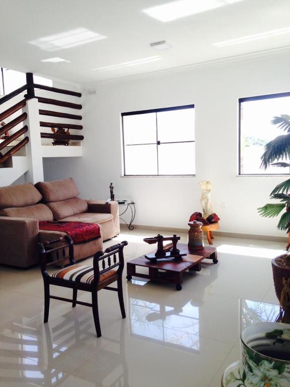a living room with a couch and a table at Pousada Manacá in São José do Rio Pardo