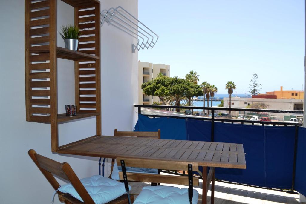 a table and chairs on a balcony with a view at Apartamento Rosamar, sea view in Los Cristianos