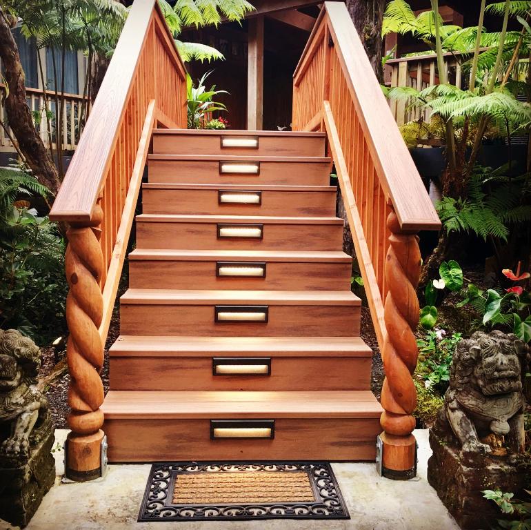 a stairway with wooden steps in a garden at At the Craters Edge in Volcano