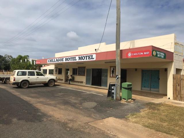 cars parked in front of a gas station at Chillagoe Cockatoo Hotel Motel in Chillagoe