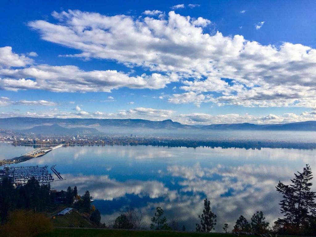 a view of a lake with clouds in the sky at Lake and Bridge View Vacation Home in West Kelowna