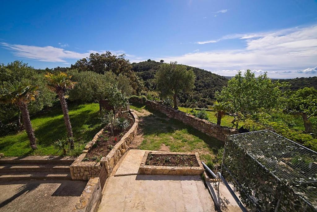 a view of a garden with trees and bushes at Holiday House Rab in Rab
