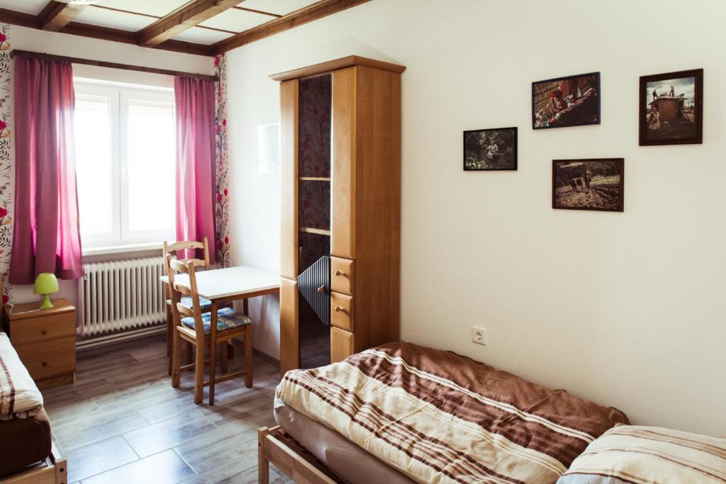 a bedroom with a bed and a table and a desk at Monteurzimmer Linde in Limbach