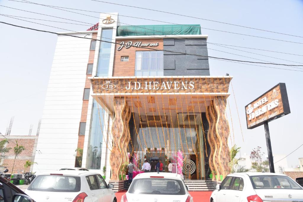 a store front with cars parked in front of it at HOTEL JD HEAVENS in Jhajjar