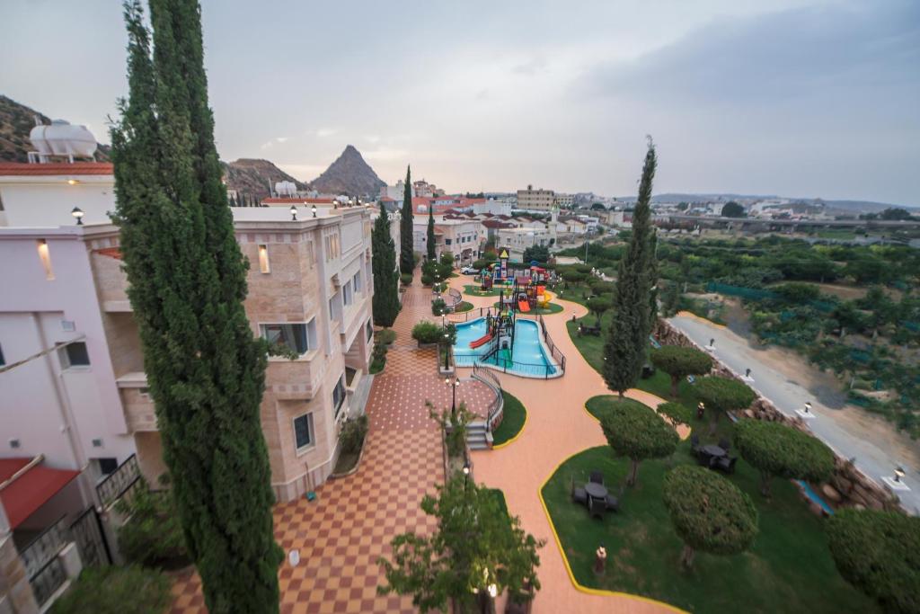 an overhead view of a park with a playground at Seven Gardens Pro in Al Hada