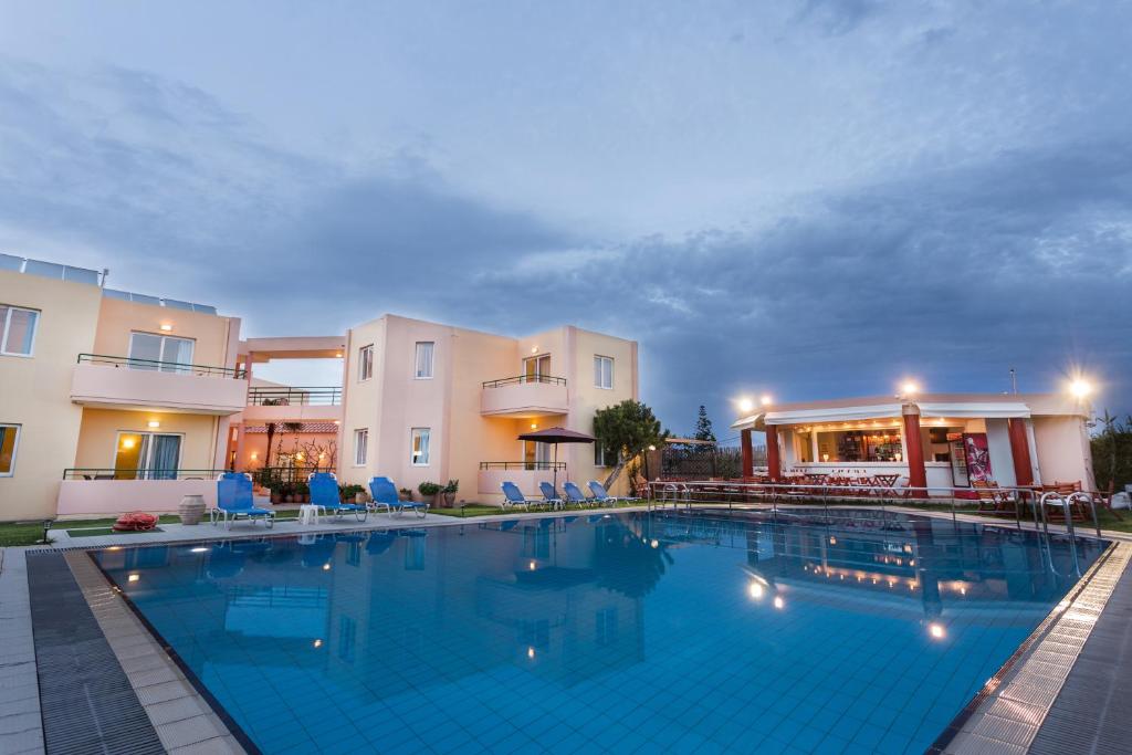 a large swimming pool in front of a building at Alonia Hotel Apartments in Kolymvari