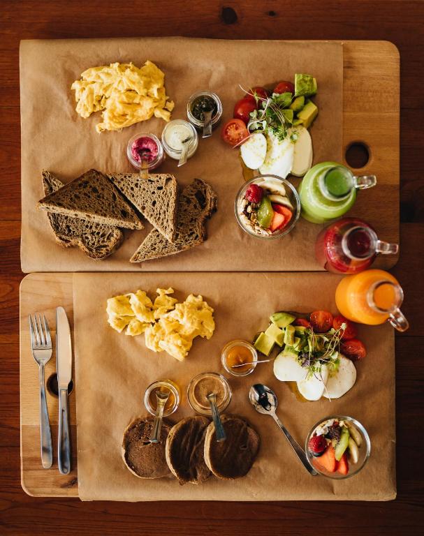 a wooden table with a tray of food on it at GiG Capsule Hostel in Ericeira
