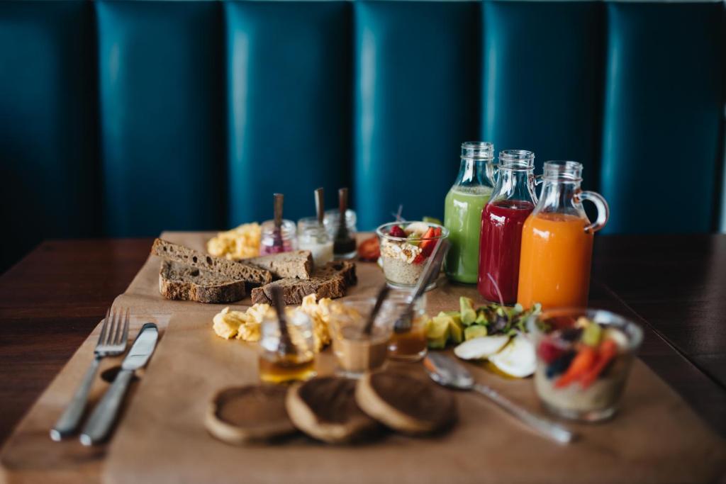 a table topped with food and bottles of juice at GiG Capsule Hostel in Ericeira