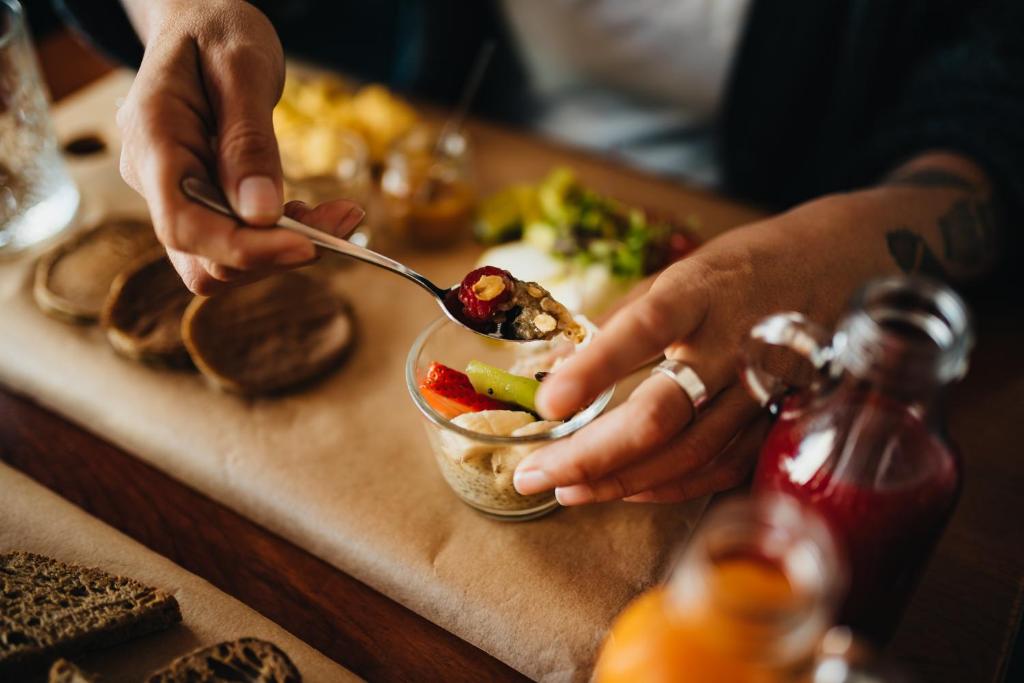 a person eating a bowl of food on a table at GiG Capsule Hostel in Ericeira
