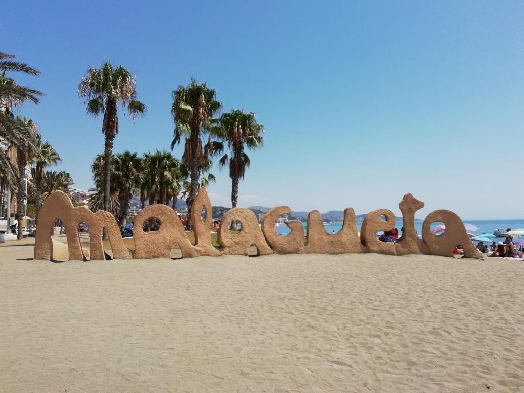 a sign on the beach spelling out the wordulum at Canovas by the Bull Ring in Málaga