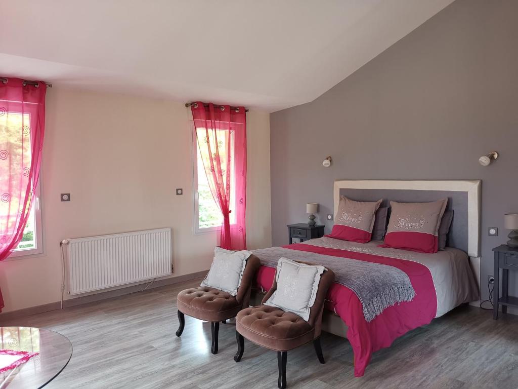 a bedroom with a large bed with red curtains at Chambre d'Hôtes du Bois Joli in Mesnard-la-Barotière