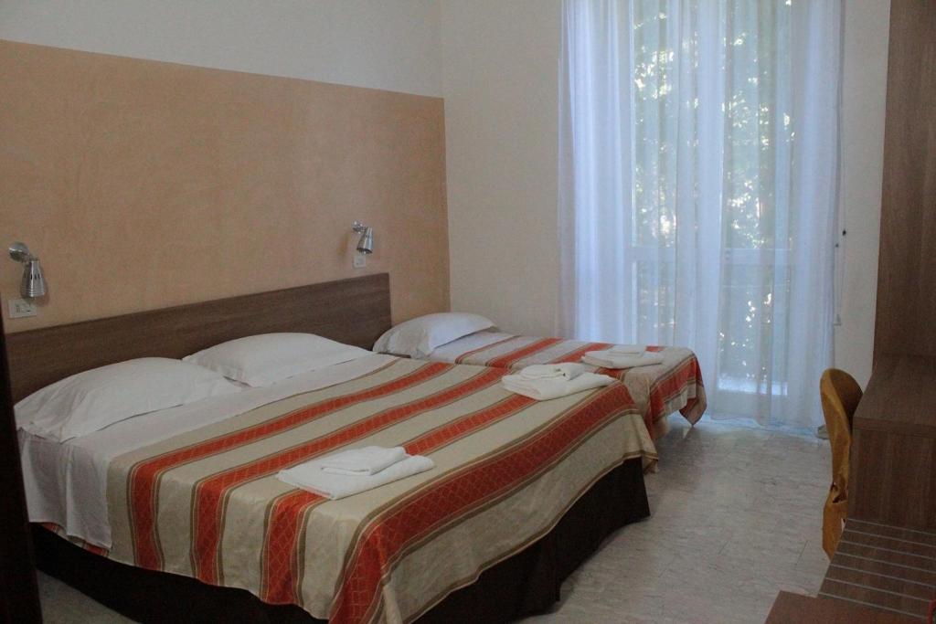 Postel nebo postele na pokoji v ubytování Hotel Derna