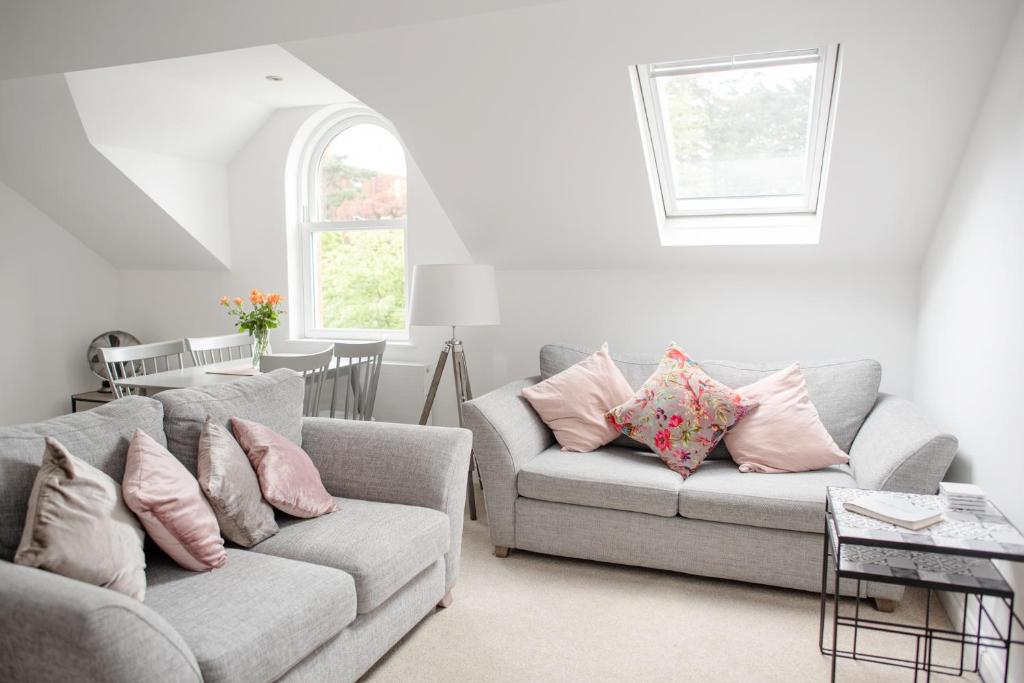 a living room with two couches and a window at Arch View in Whitby