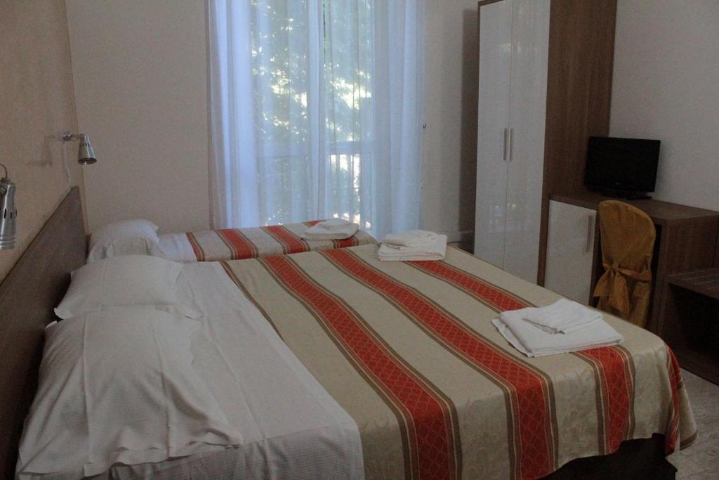 Postel nebo postele na pokoji v ubytování Hotel Derna