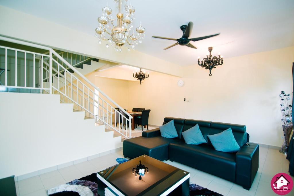 a living room with a couch and a chandelier at Dream Borneo Budget Homestay Kota Kinabalu in Penampang