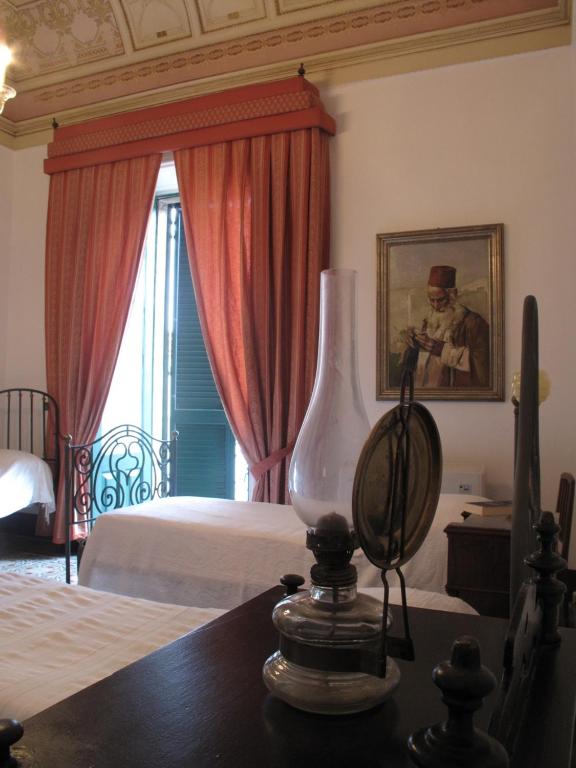 Postel nebo postele na pokoji v ubytování B&B di Charme Camelie Palazzo Nicotra