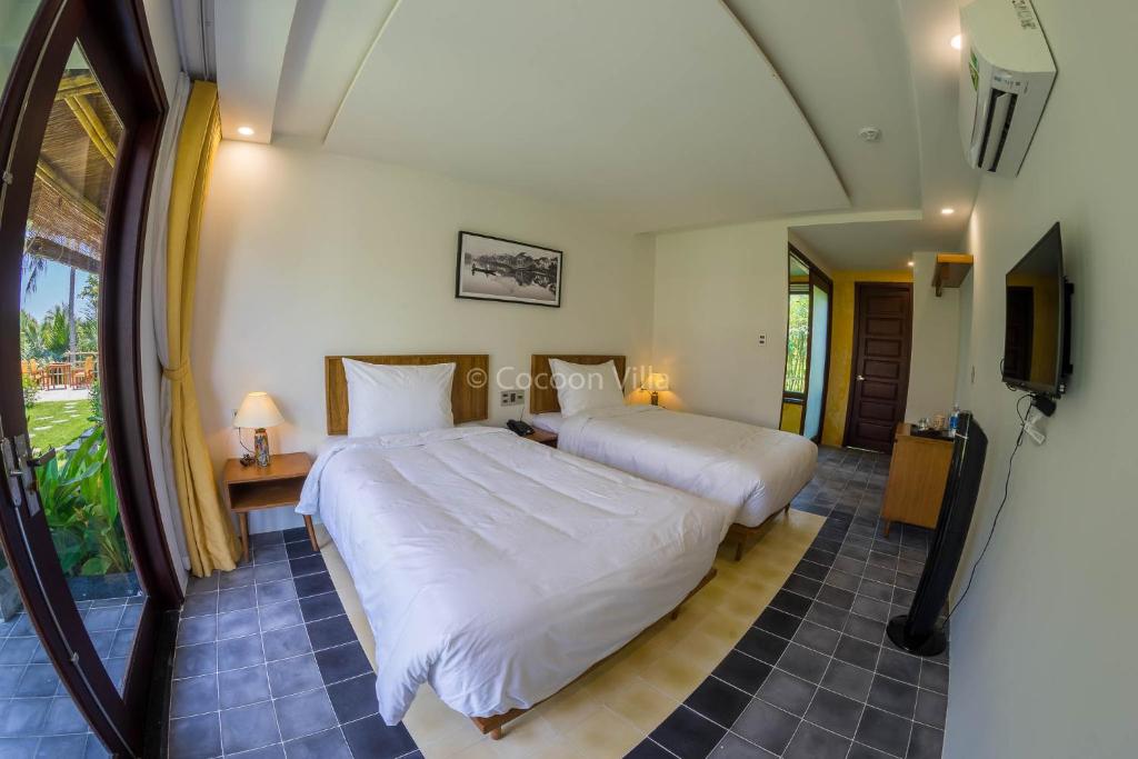 Postel nebo postele na pokoji v ubytování Cocoon Villa