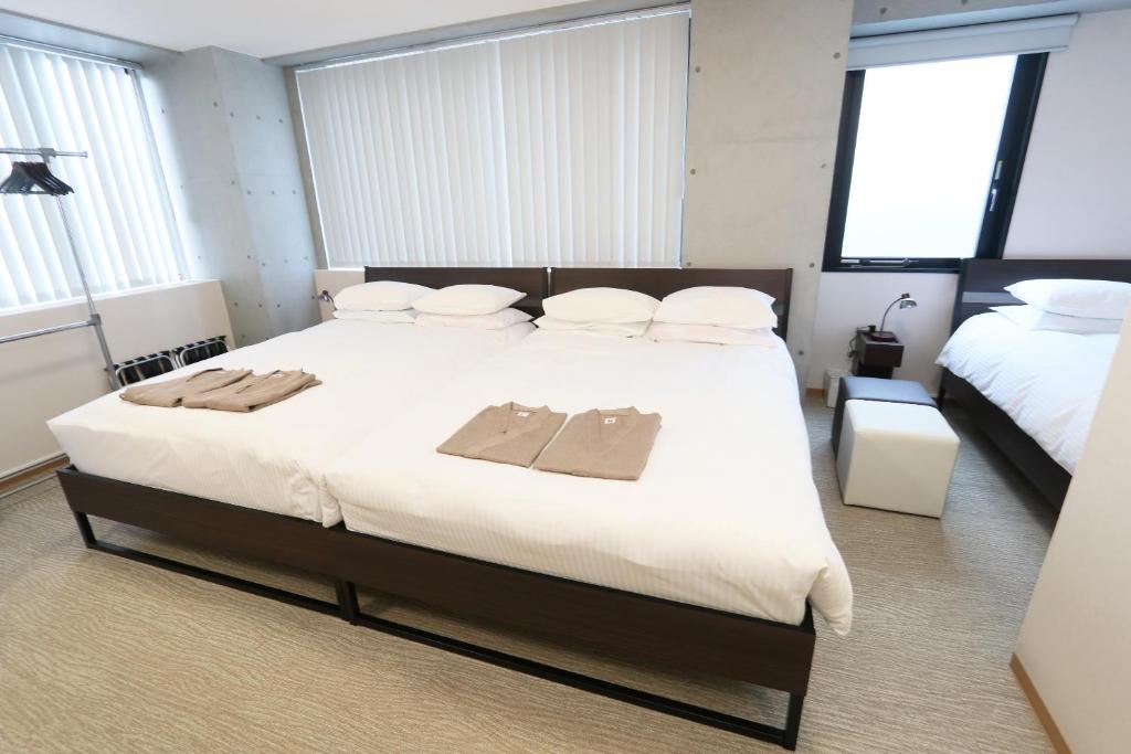 Postel nebo postele na pokoji v ubytování Business Capsule Hotel Lightning Hotel Asakusa