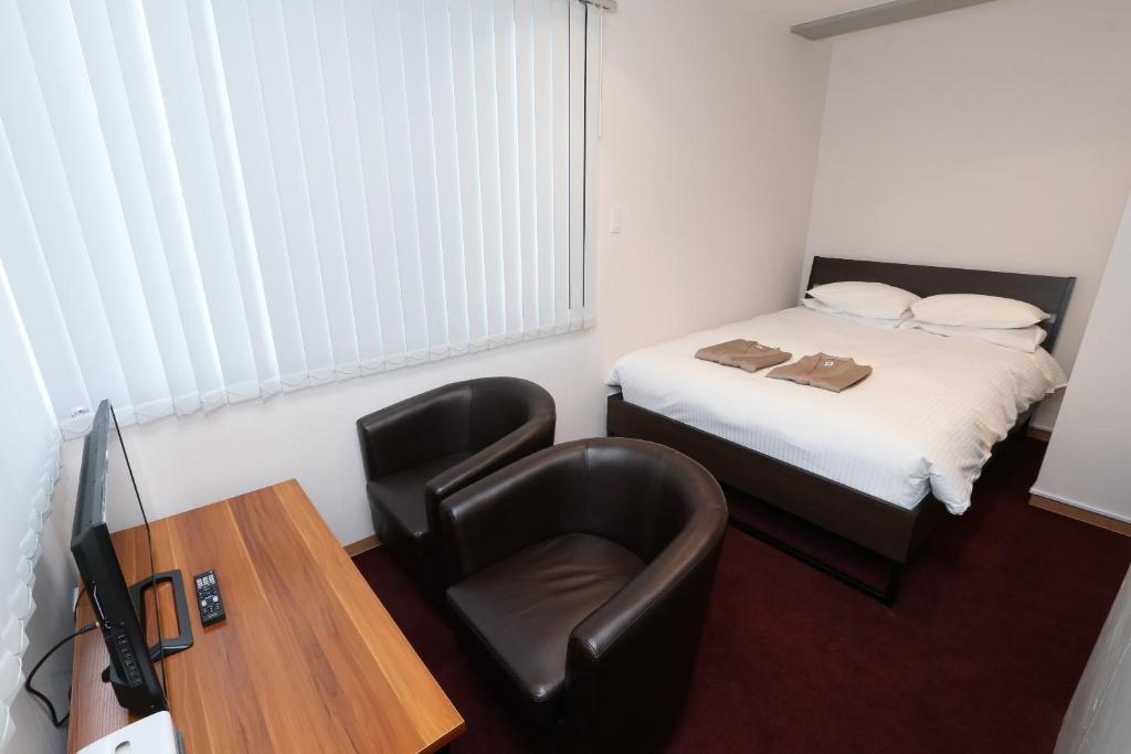Postel nebo postele na pokoji v ubytování Business Capsule Hotel Lightning Hotel Asakusa