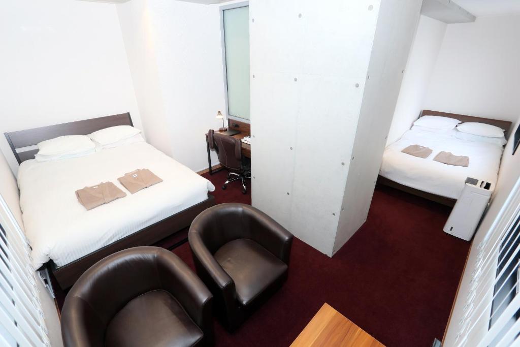 Postel nebo postele na pokoji v ubytování Business Capsule Hotel Lightning Hotel Asakusa
