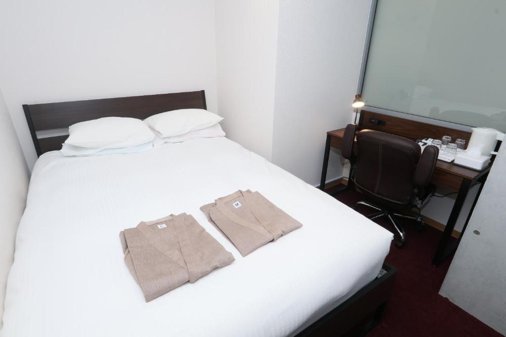 Postel nebo postele na pokoji v ubytování Business Capsule Hotel Lightning Hotel Asakusa