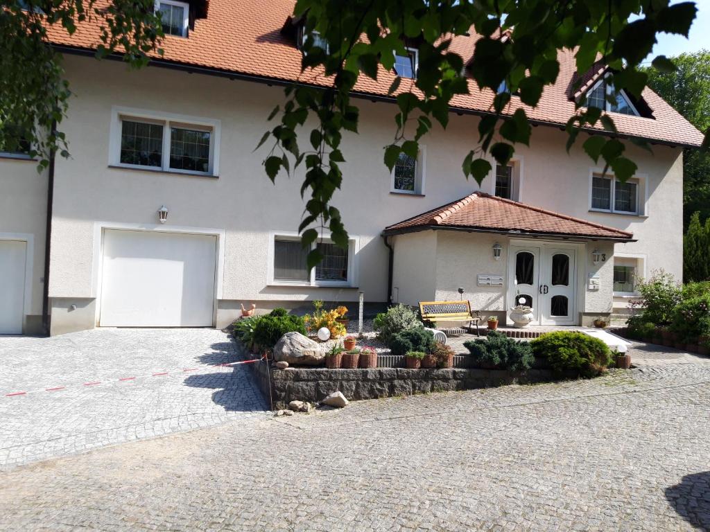 a large white house with a white garage at Ferien in Sachsen in Bischofswerda