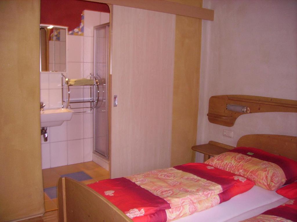 a small room with a bed and a bathroom at Ferienwohnungen Veit in Aigen im Mühlkreis