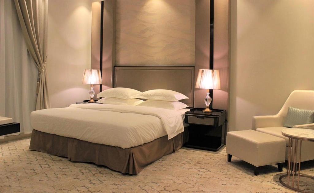 A bed or beds in a room at Malfa Hotel Apartments