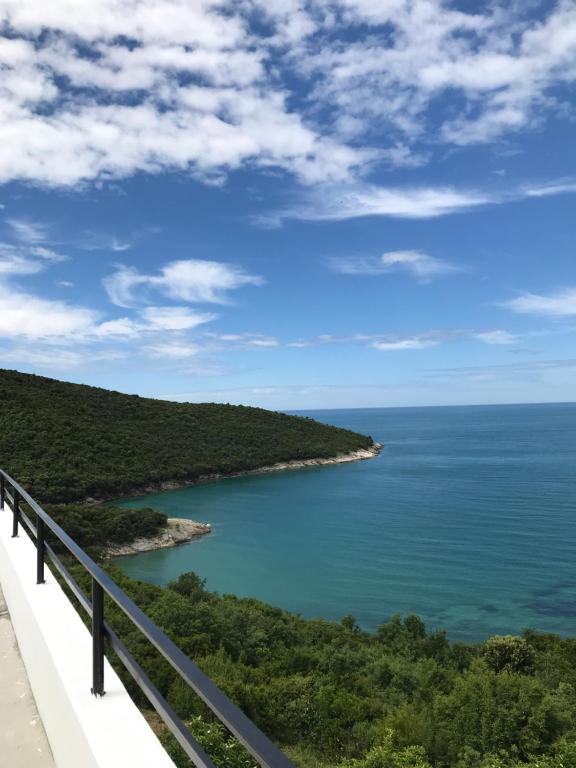 a view of the ocean from a bridge at Apartments Blue Heaven in Ulcinj