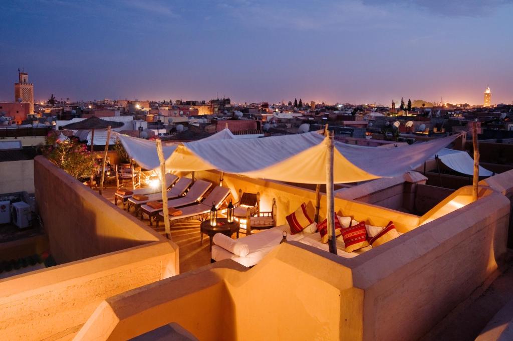 a view of a rooftop with umbrellas and chairs at Riad Dar Hanane in Marrakesh