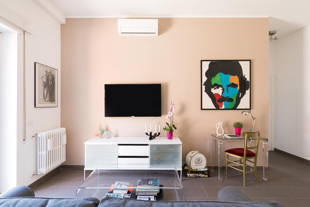 a living room with a tv on a wall at Galeria Home Apartments in Anguillara Sabazia