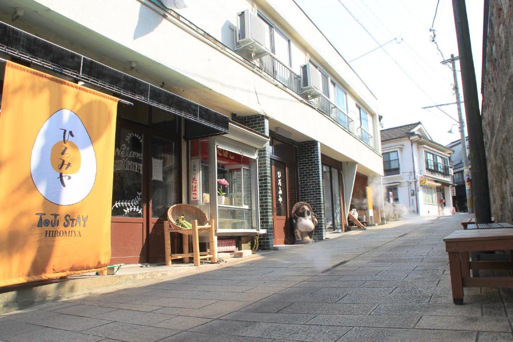 a street with a sign on the side of a building at Beppu Kannawa Onsen HIROMIYA in Beppu