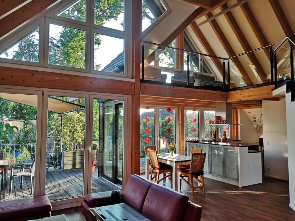 an open kitchen and living room with large windows at Ferienloft Dalum in Geeste