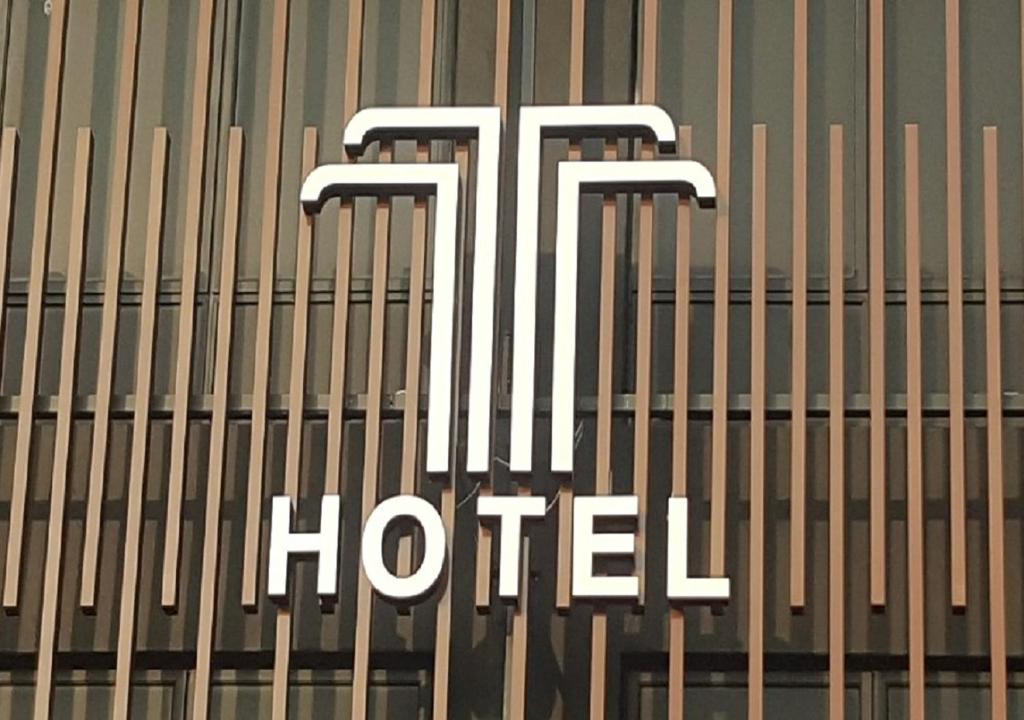 a hotel sign on the side of a building at T Hotel Johor Bahru in Skudai