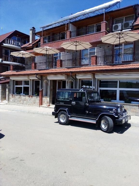 a black truck parked in front of a building at Doctor's House in Sinemorets
