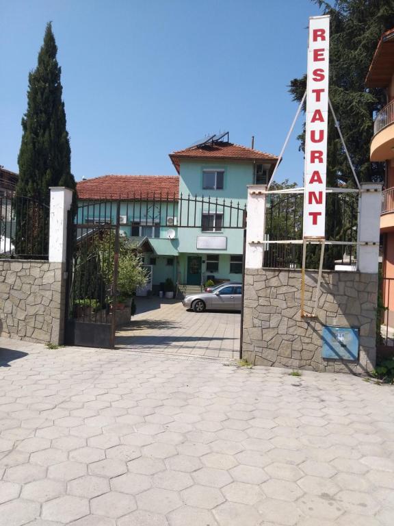 a sign for a hotel in front of a building at Hotel Tsarevets in Asenovgrad