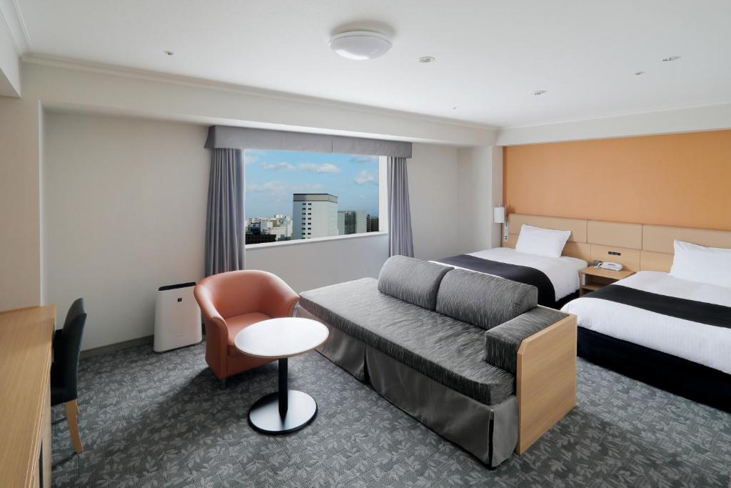 Postel nebo postele na pokoji v ubytování Sapporo Excel Hotel Tokyu