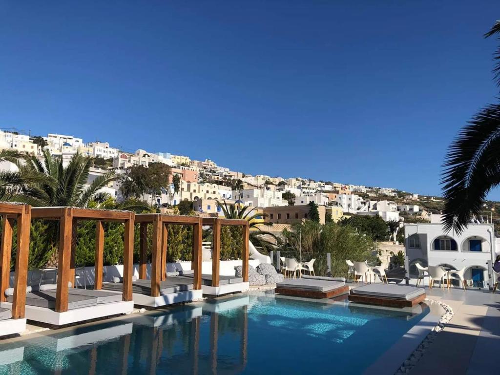 a swimming pool with a balcony overlooking the ocean at Callia Retreat Suites - Adults Only in Fira
