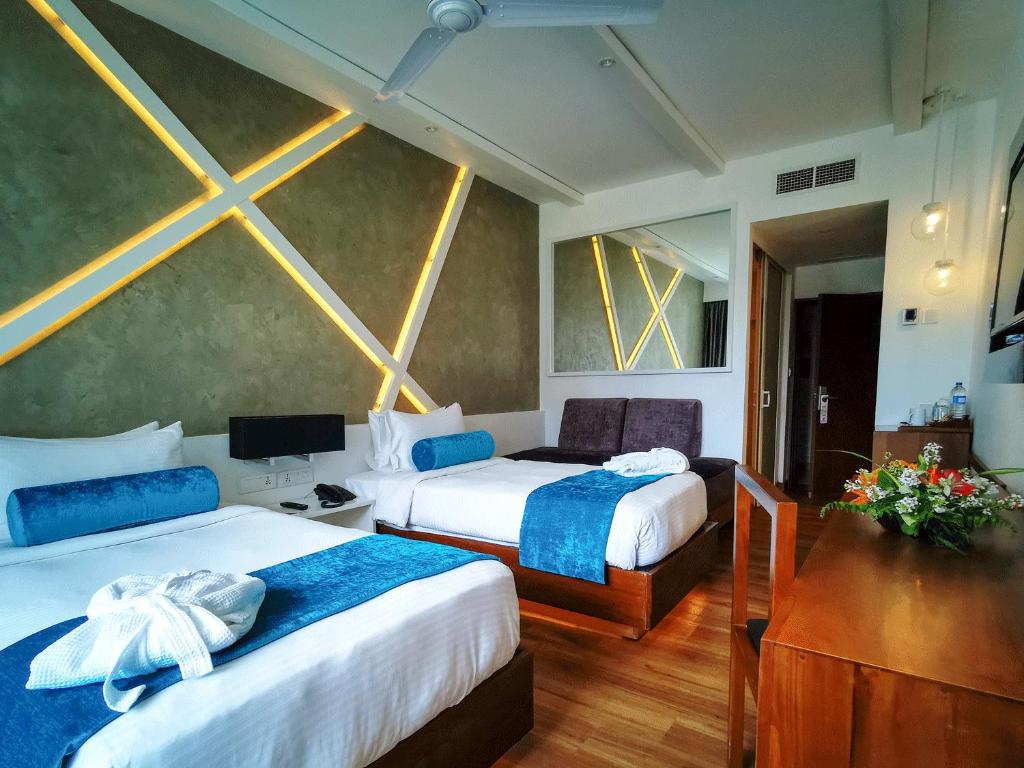 Postel nebo postele na pokoji v ubytování Camelot Beach Hotel