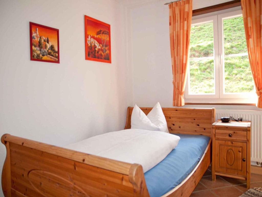 a bedroom with a bed and a window at Vogtadeshof in Wolfach