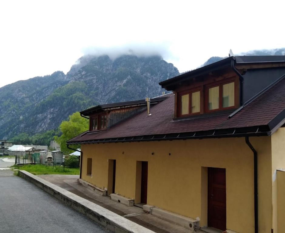 a house on the side of a road with a mountain at HOME PREDIL in Tarvisio