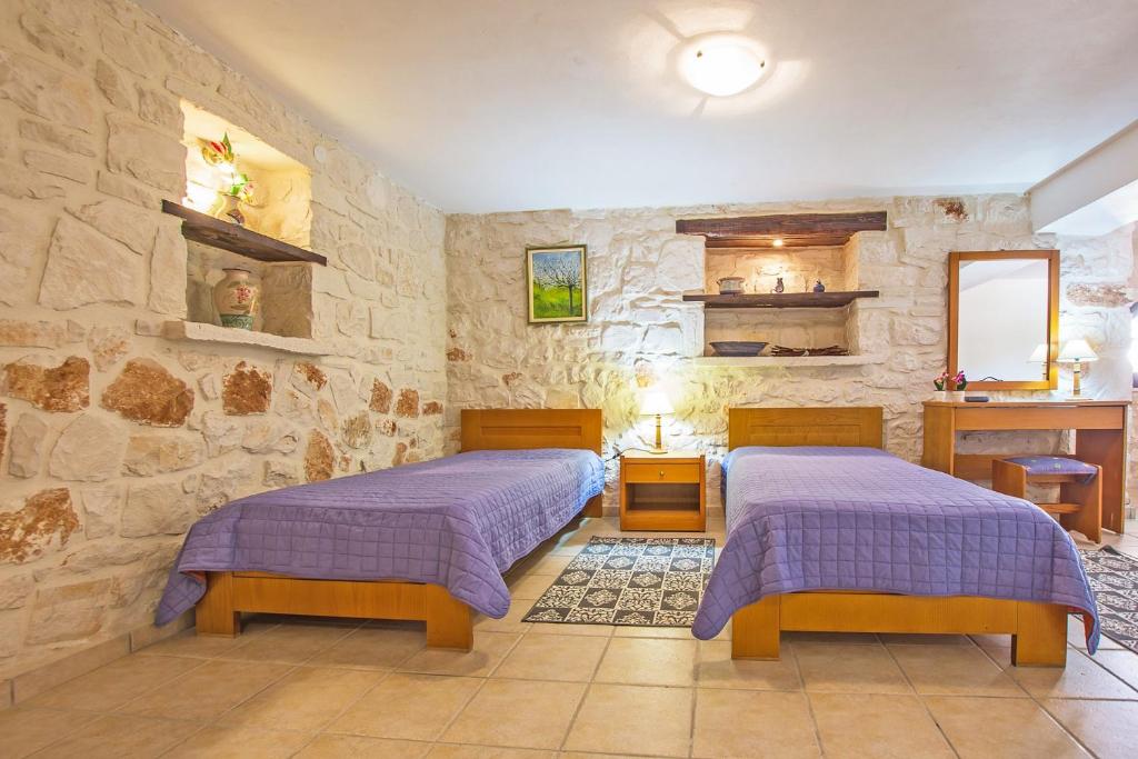 A bed or beds in a room at The Vivian - Luxury Stone Villa